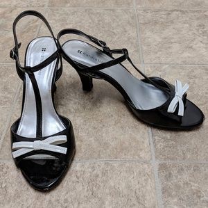 Black with white bow faux patent leather heels